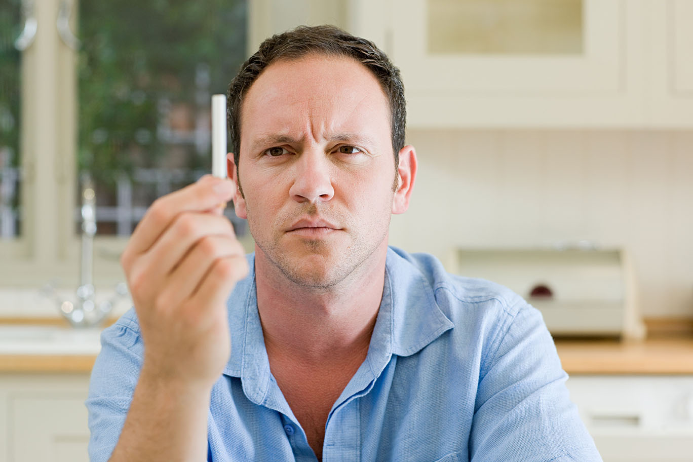 Man looking at cigarette