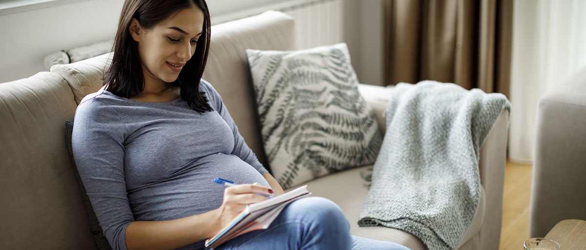 Pregnant woman making notes