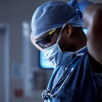 Shot of a surgeon putting on his surgical mask in preparation for a surgery